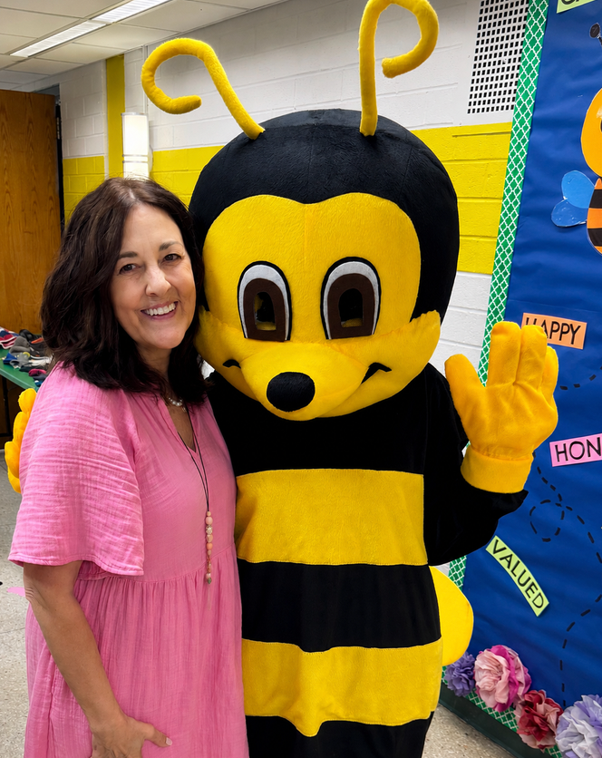 Laura Heitman with students — owner of Bees to Blossoms Books